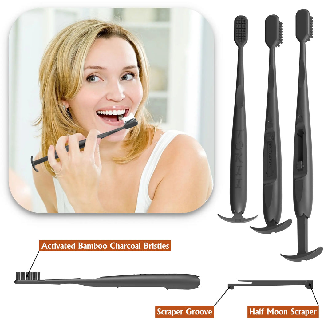 Black toothbrush with activated bamboo charcoal bristles, scraper groove, and half moon scraper on a white background.
