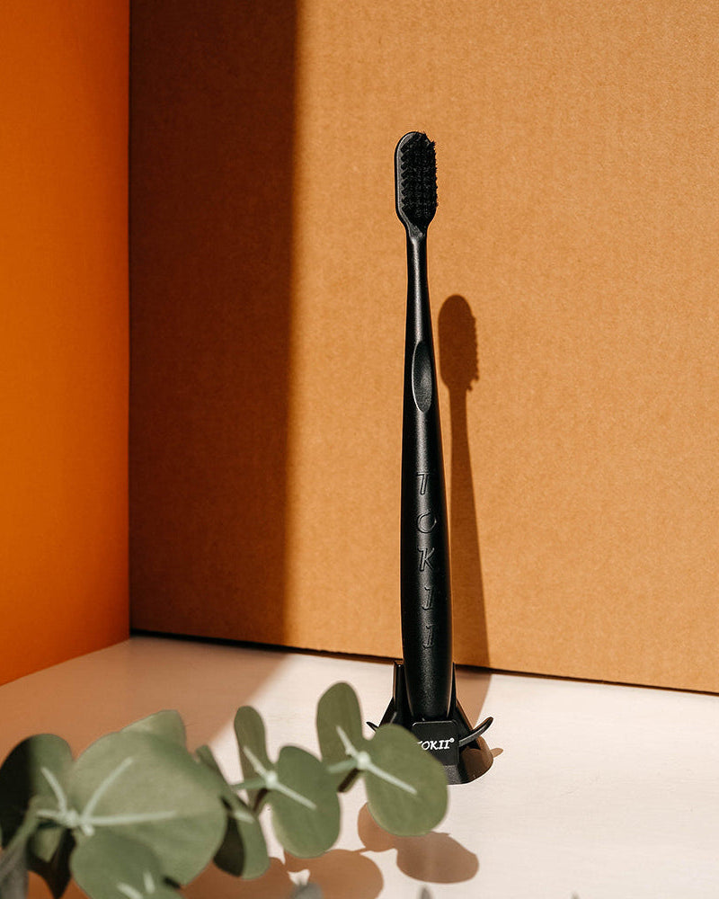 Tokii –  Toothbrush with attached Sliding Tongue Scraper